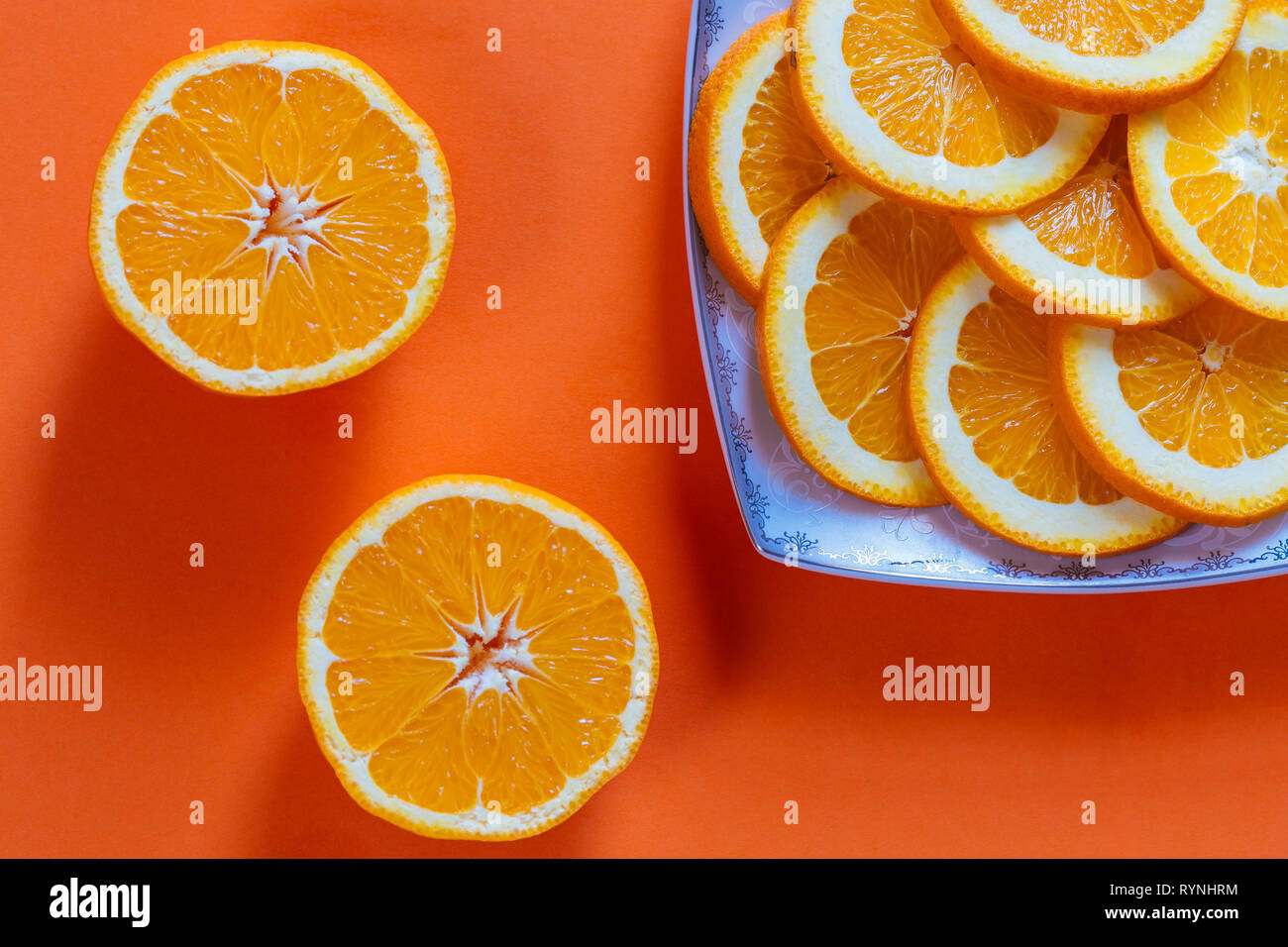 Sliced oranges on a orange background Stock Photo