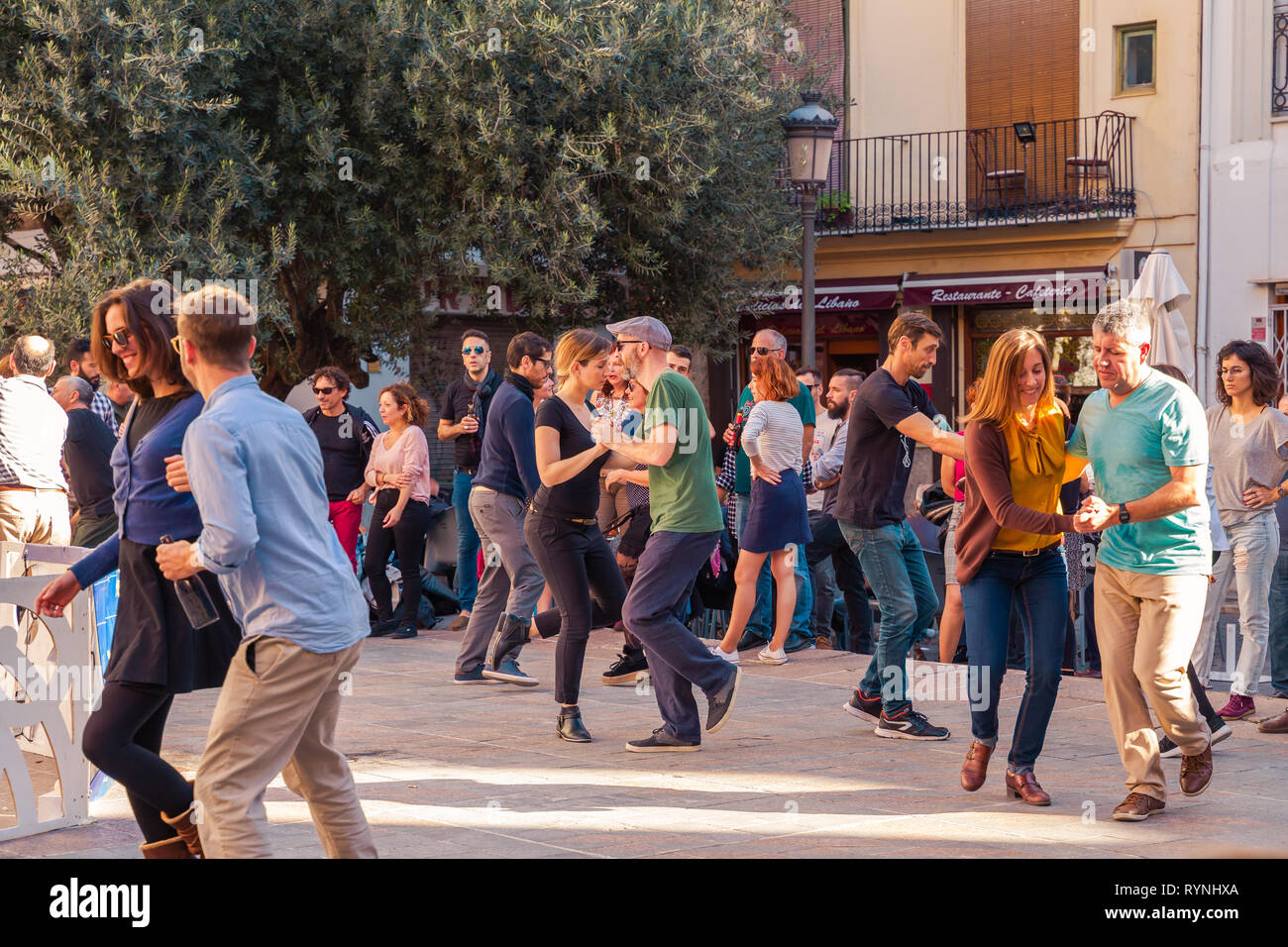 Valencia, Spain; December 2 2018: People dancing on the street during holiday. Young stylish couple dance. Having a good time. Stock Photo