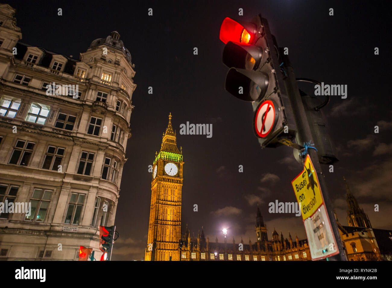 Red street light on Parliament street with Big Ben in the background Stock Photo