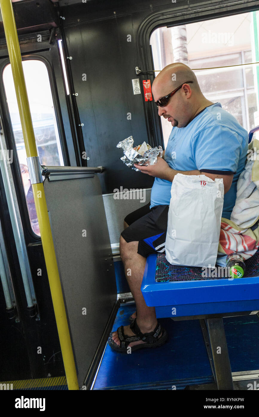 Miami Beach Florida,Metrobus,South Beach Local,public transportation,mass transit,seat,passenger passengers rider riders,Hispanic Latin Latino ethnic Stock Photo