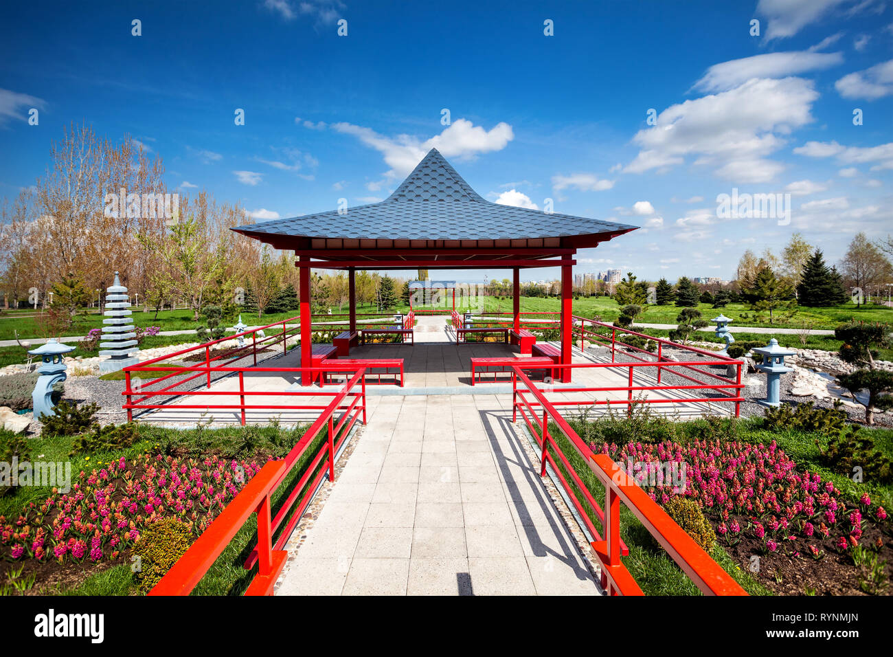 Japanese garden with red pagoda and blue sky in dendra park of first president in Almaty, Kazakhstan Stock Photo