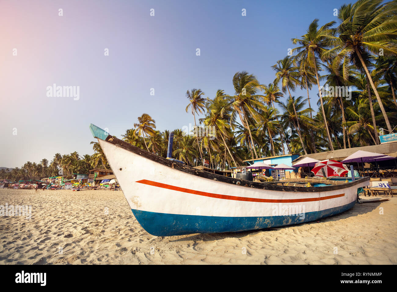 Fisherman boat on the beach at sunset at Palolem beach in Goa, India Stock Photo