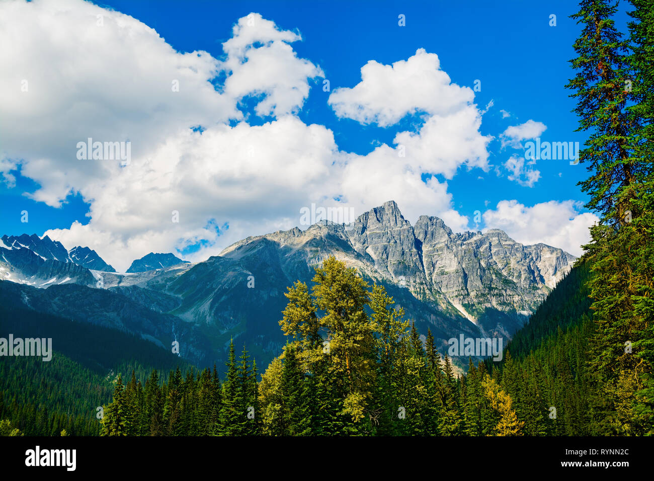 Fluffy clouds over Canadian Rockies Stock Photo