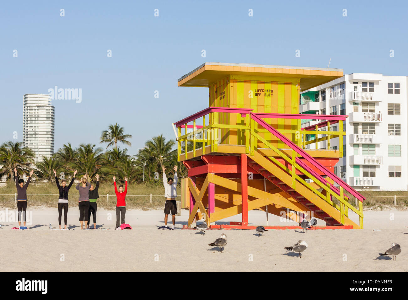 Miami Beach Florida,Atlantic Ocean,water,public beach,lifeguard station,hut,yoga,group,class,stretching,FL090215152 Stock Photo