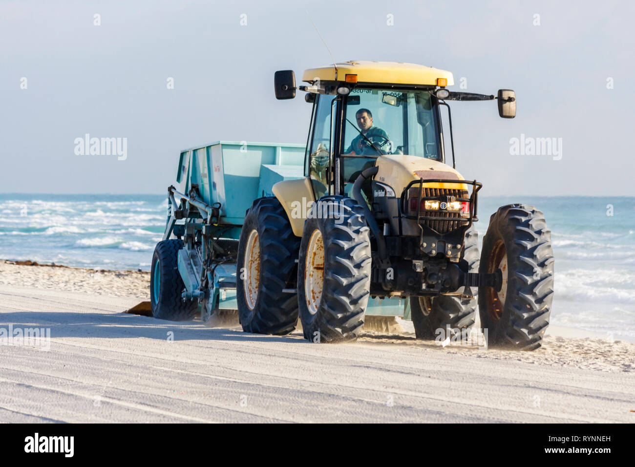 Miami Beach Florida,Atlantic Ocean,water,public beach,cleaning,cleaner,tractor,pulling,machine,sift,sand,litter,city,employee worker workers working s Stock Photo