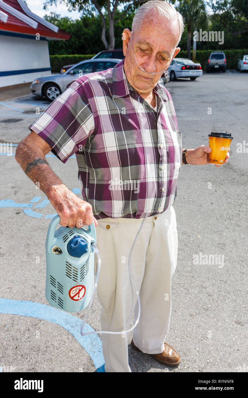 Florida Boynton Beach,portable oxygen unit,machine,man men male,senior seniors citizen citizens,breathing,health,lungs,pulmonary disease,illness,breat Stock Photo