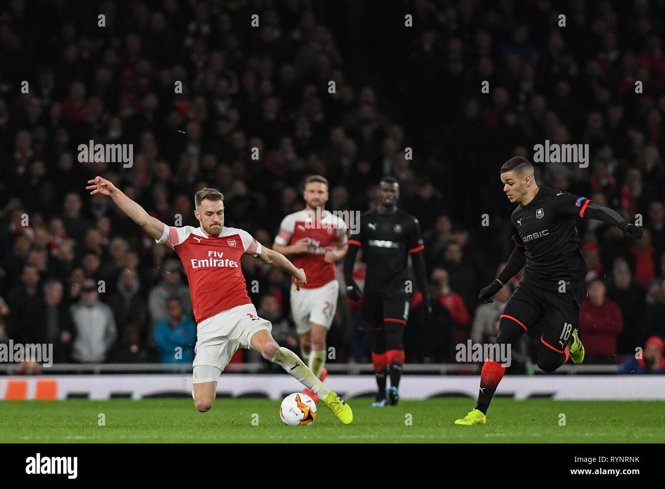 14th March 2019 , Emirates Stadium, London, England; Europa League, Round Of 16, 2nd Leg, Arsenal vs Rennes ; Aaron Ramsey (08) of Arsenal  stretches for the ball from Hatem Ben Arfa (18) of Rennes  Credit:  Phil Westlake/News Images Stock Photo