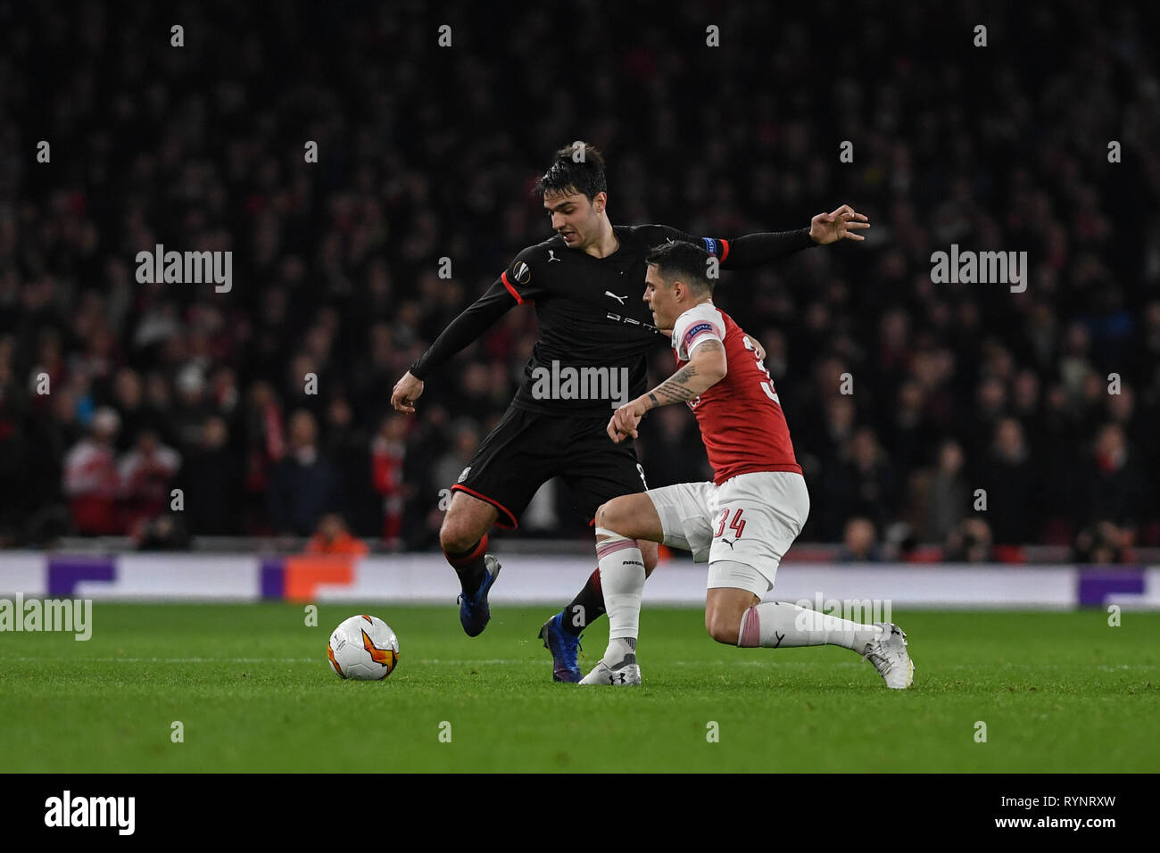 14th March 2019 , Emirates Stadium, London, England; Europa League, Round Of 16, 2nd Leg, Arsenal vs Rennes ; Grenier (8) of Rennes trees to beat Granit Xhaka (34) of Arsenal   Credit:  Phil Westlake/News Images Stock Photo
