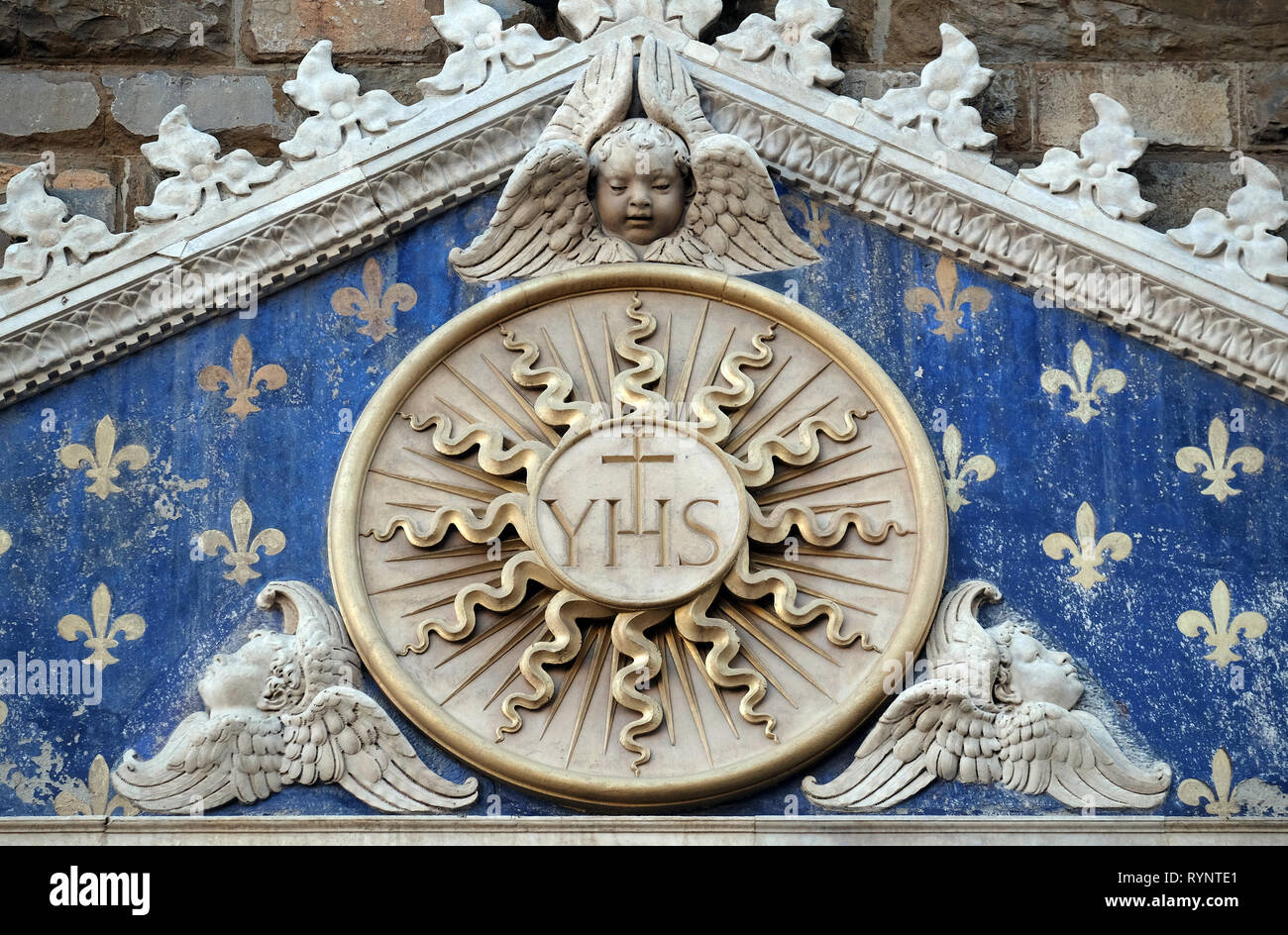 Medallion with the IHS monogram between two lions, above to the entrance to Palazzo Vecchio, a UNESCO World Heritage Site in Florence, Italy Stock Photo