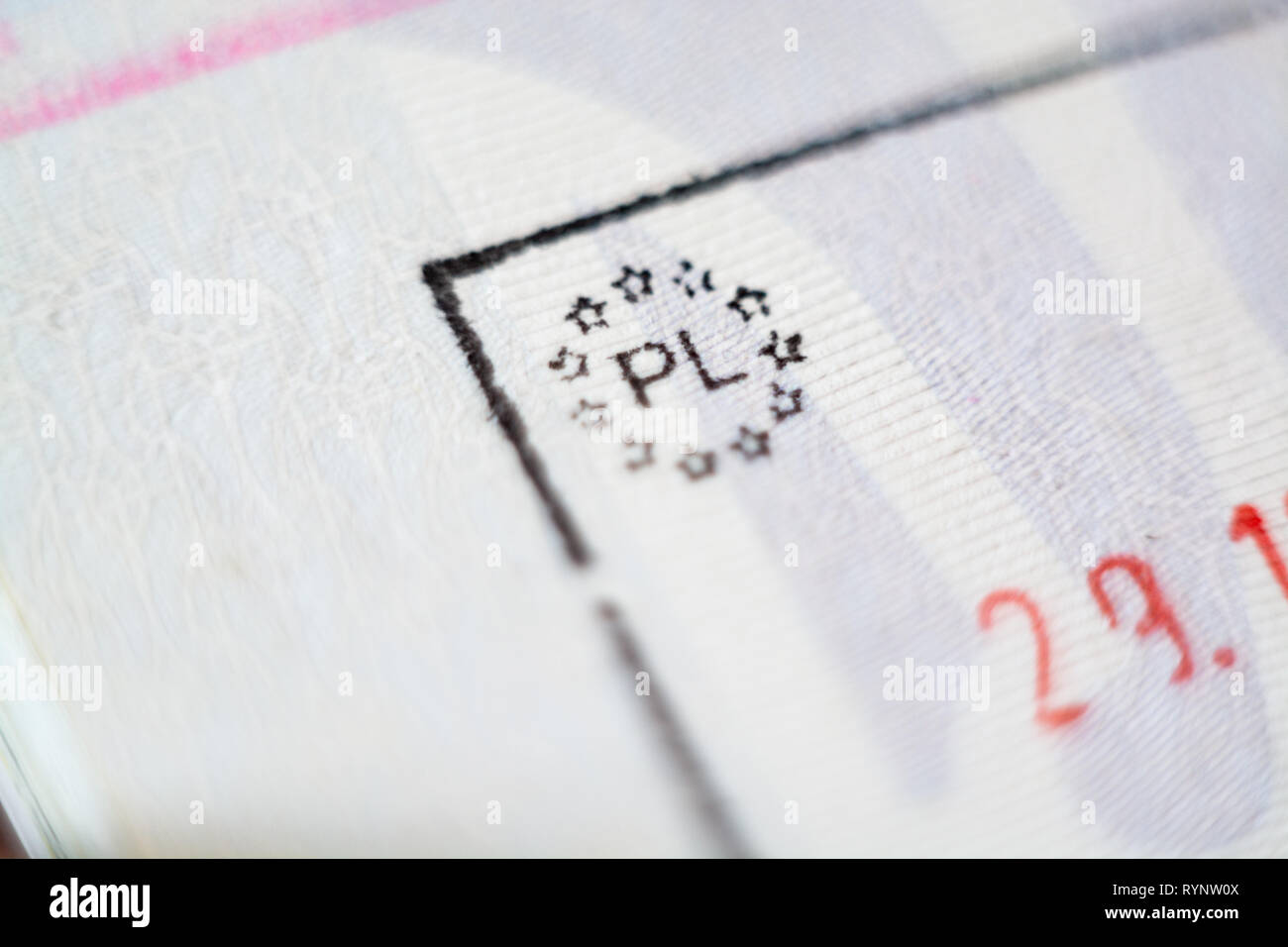 Close-up macro detail of European Union border control customs admission stamp with exit symbol in focus and Poland country marking sign Stock Photo
