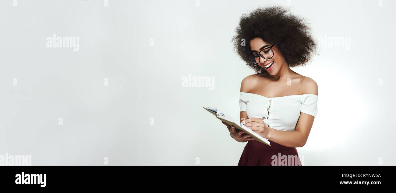 Cute african woman reading book hi-res stock photography and images - Alamy