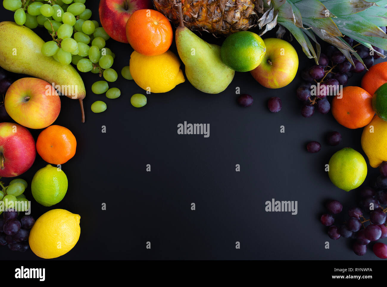 different fresh healthy fruits on black background Stock Photo