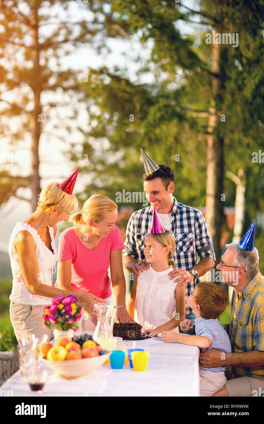 Family celebrating birthday outdoor with cake Stock Photo