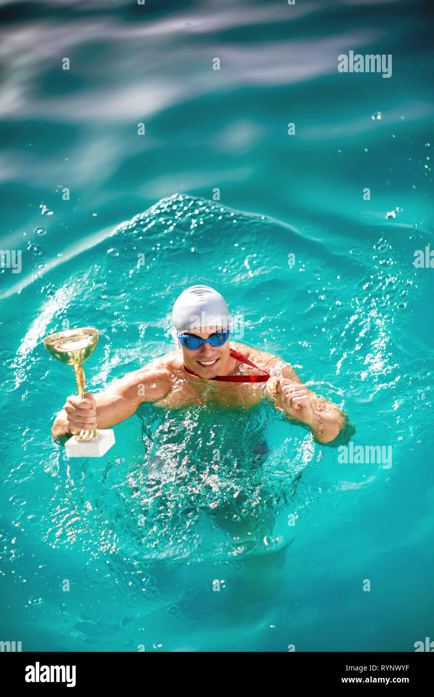 Winning Swimmer in swimming pool with Stock Photo