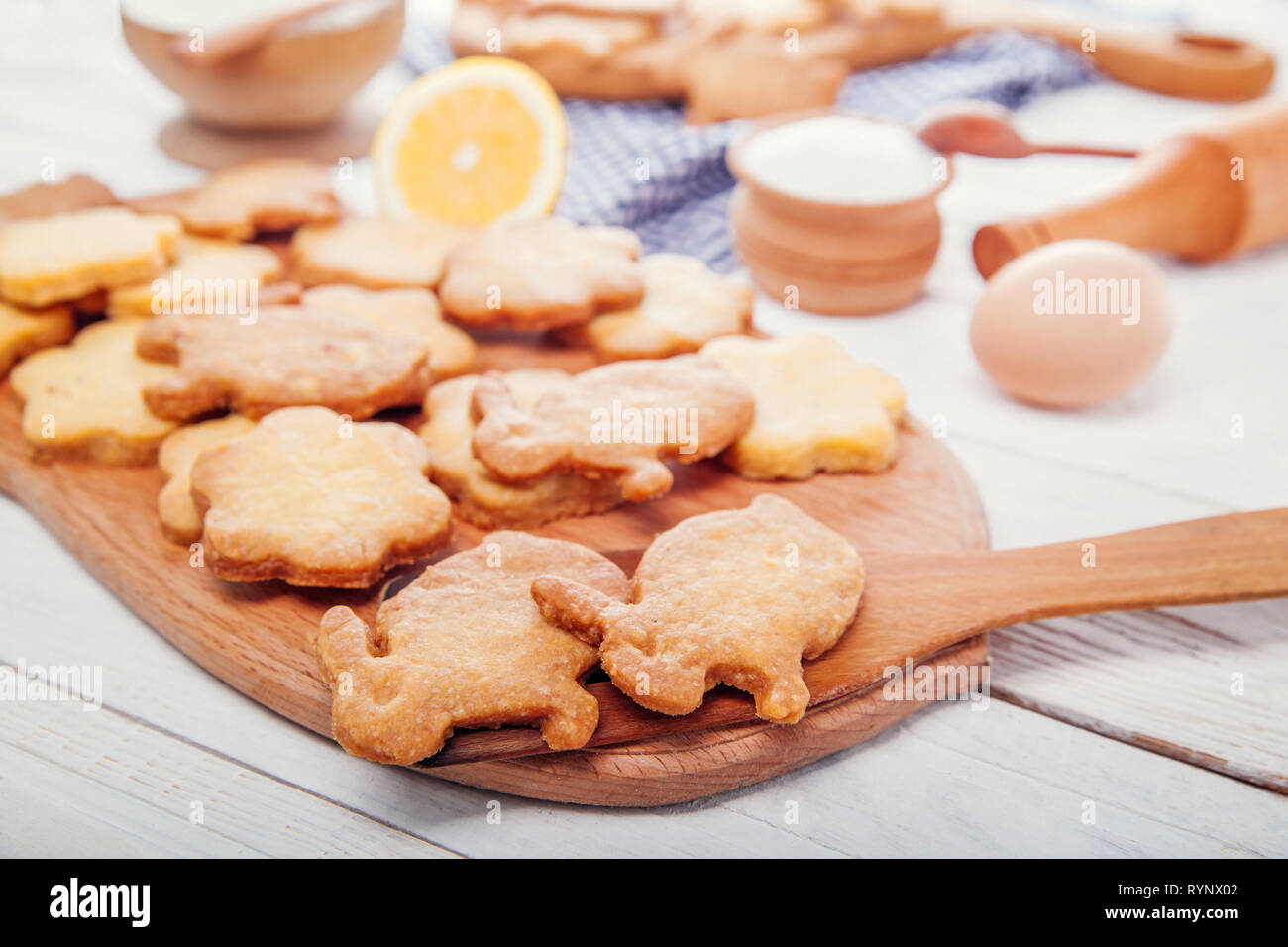 Happy Easter. Baking Easter bunnies. Ingredients with Easter decoration on wooden table Stock Photo