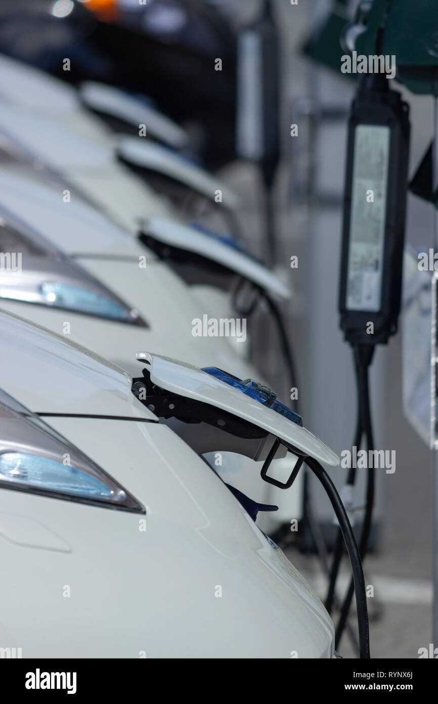 Nissan automobile Electric car (or BEV or EV / AEV / all-electric or all-battery vehicle) charging its batteries in a street charging station. Sweden. Stock Photo