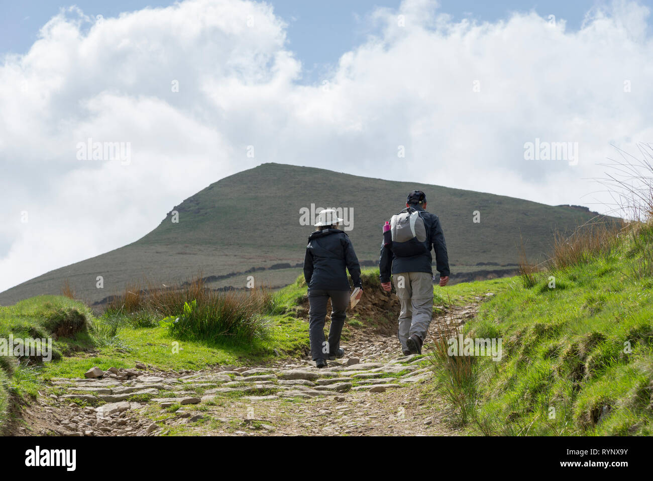 Couple hiking in the hills near Hayfield, Derbyshire in the Peak District. Mount Famine in the background. Stock Photo