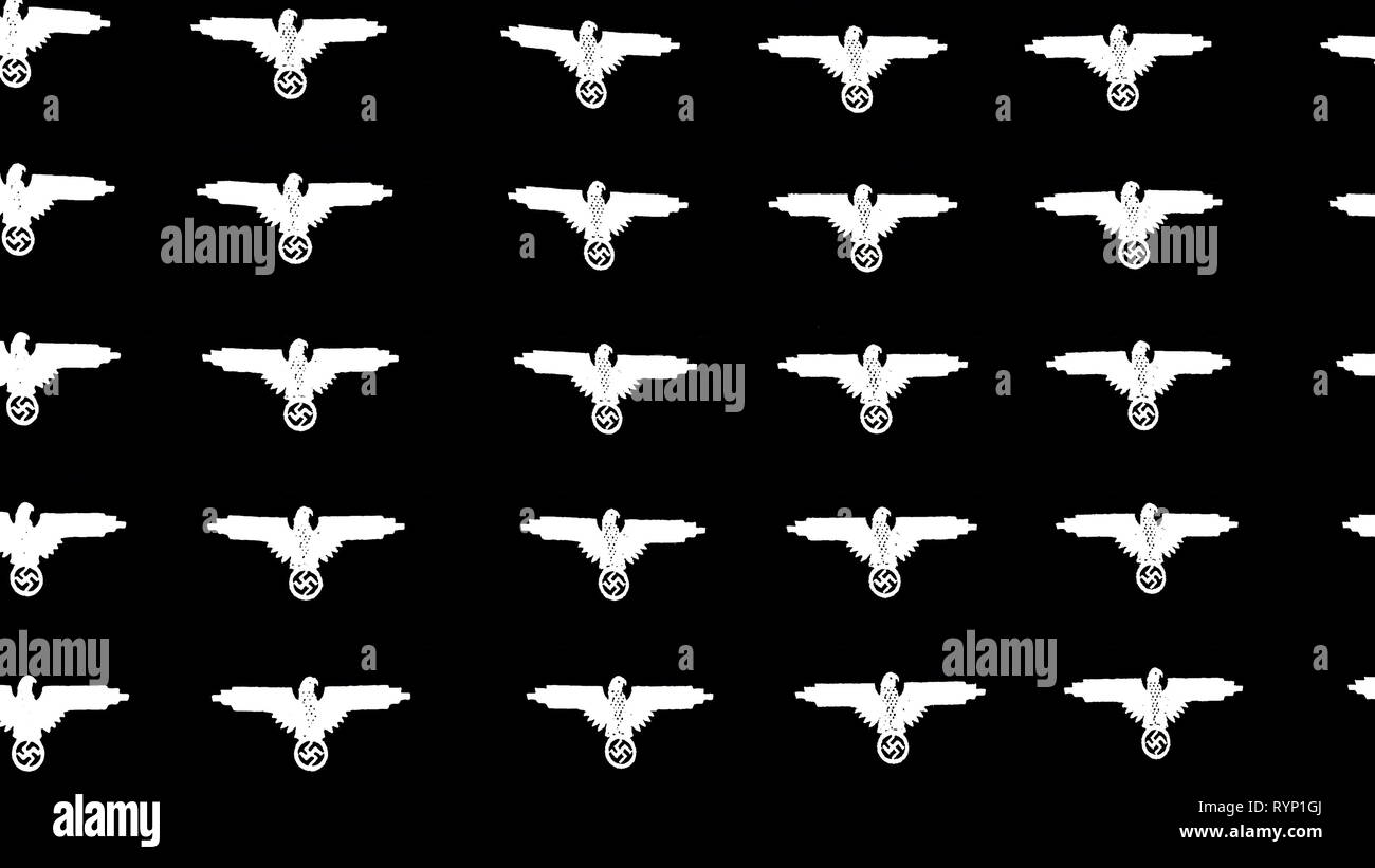 White images of the bird symbols on a black wall background from the nazi during the WorldWar II history Stock Photo