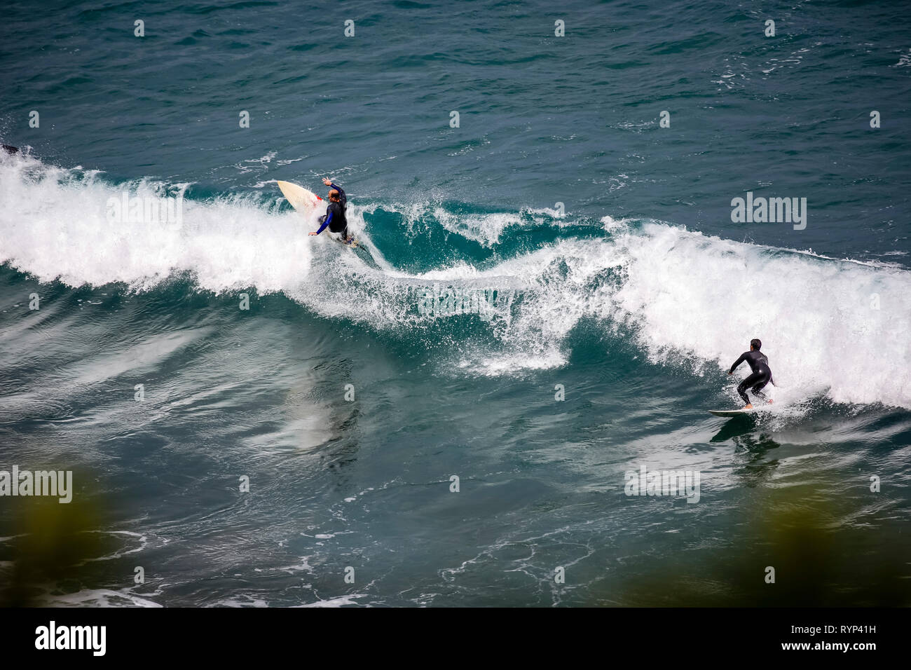 surfer standing at Piha Beach, New Zealand Stock Photo