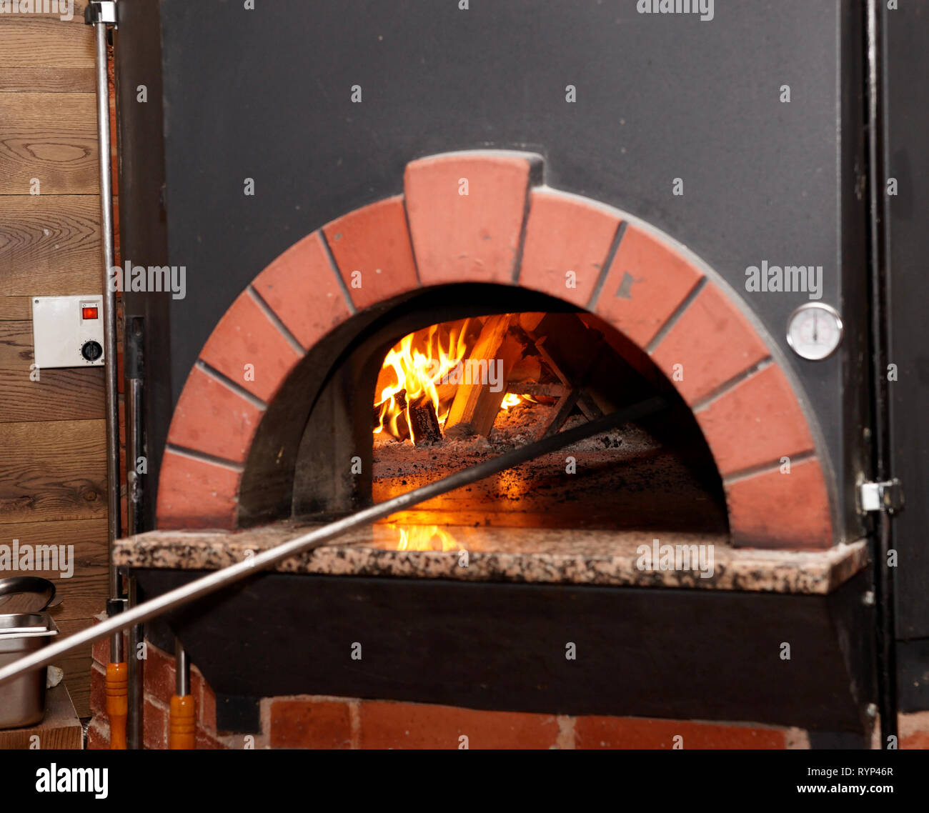 Pizza oven with wood burning inside it Stock Photo