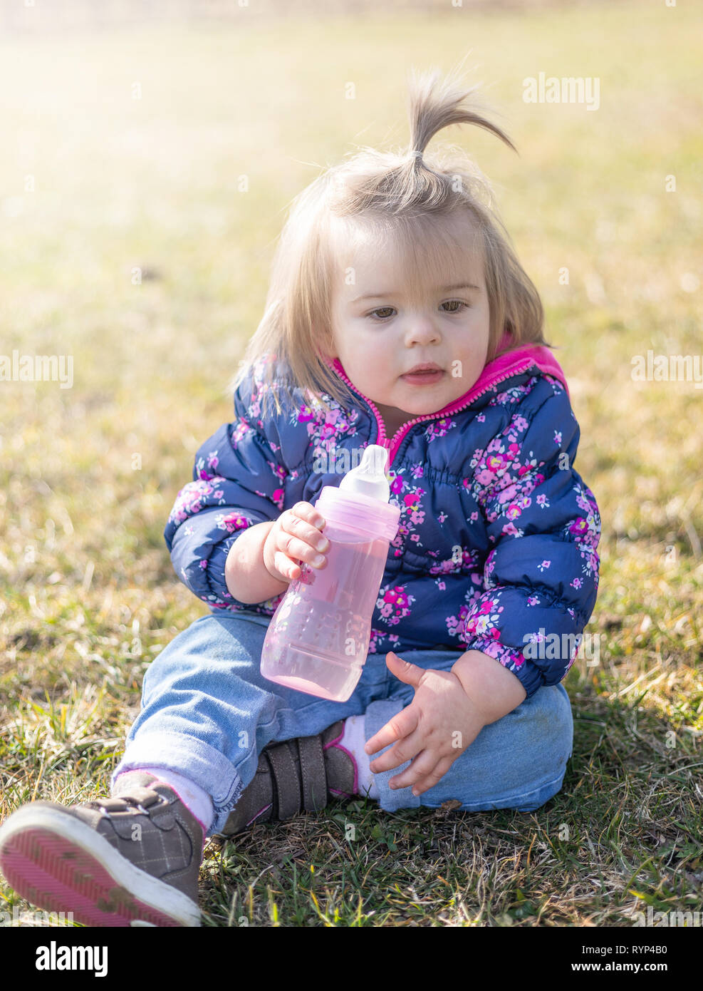 Sweet 17-Months Old Baby Girl Sitting On The Lawn And Drinking Water. Outdoor Photography Stock Photo - Alamy Sweet 17-Months Old Baby Girl Sitting On The Lawn And Drinking Water. Outdoor Photography Stock Photo - Alamy