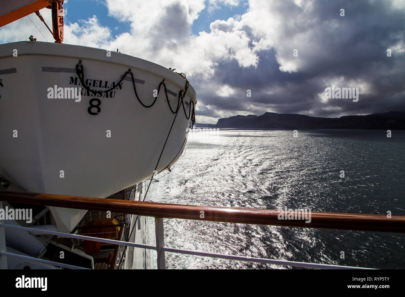 Lifeboat on ship with stunning view in background. Stock Photo
