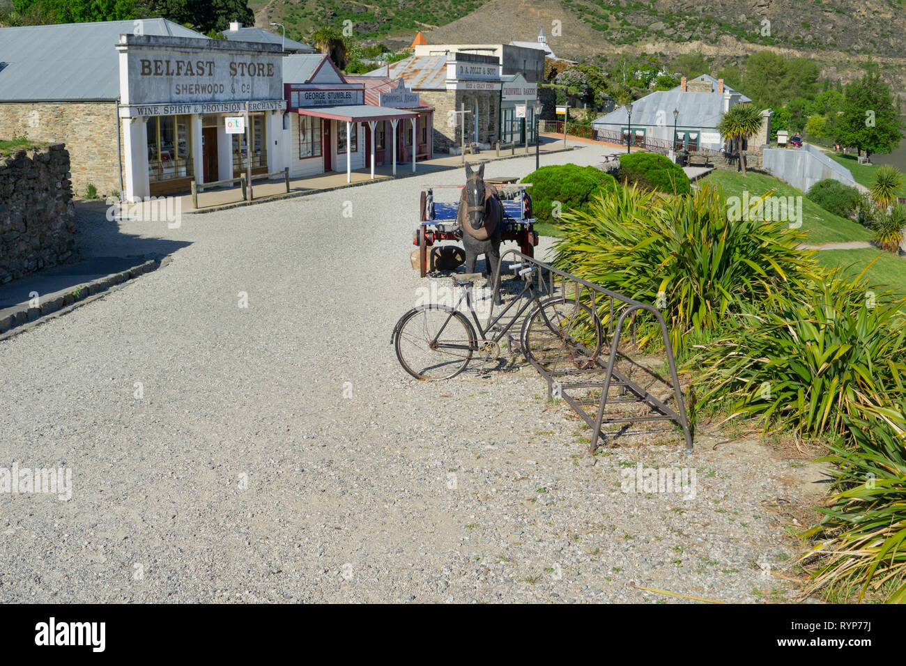 CROMWELL NEW ZEALAND - OCTOBER 21 2019; Cromwell New Zealand Heritage Precinct old gravel road in front of historic shop facades  old cycle rack and h Stock Photo