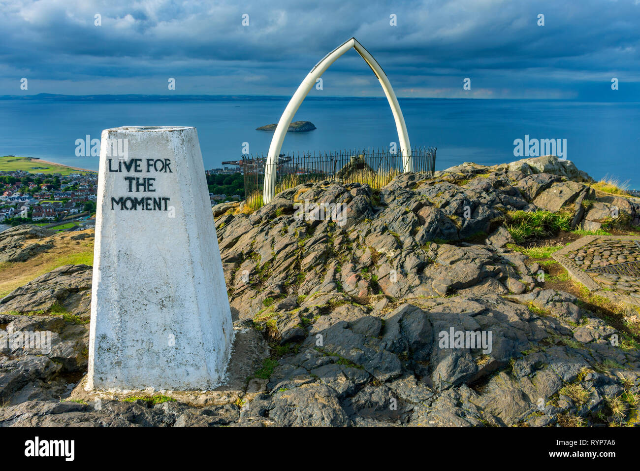 The trig point and replica whale bones on the summit of North Berwick Law, East Lothian, Scotland, UK Stock Photo