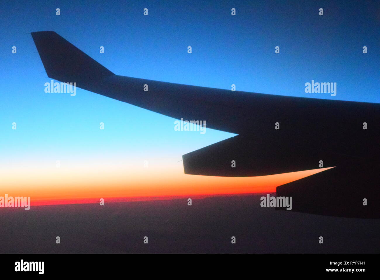 plane wing & sunrise over greenland Stock Photo