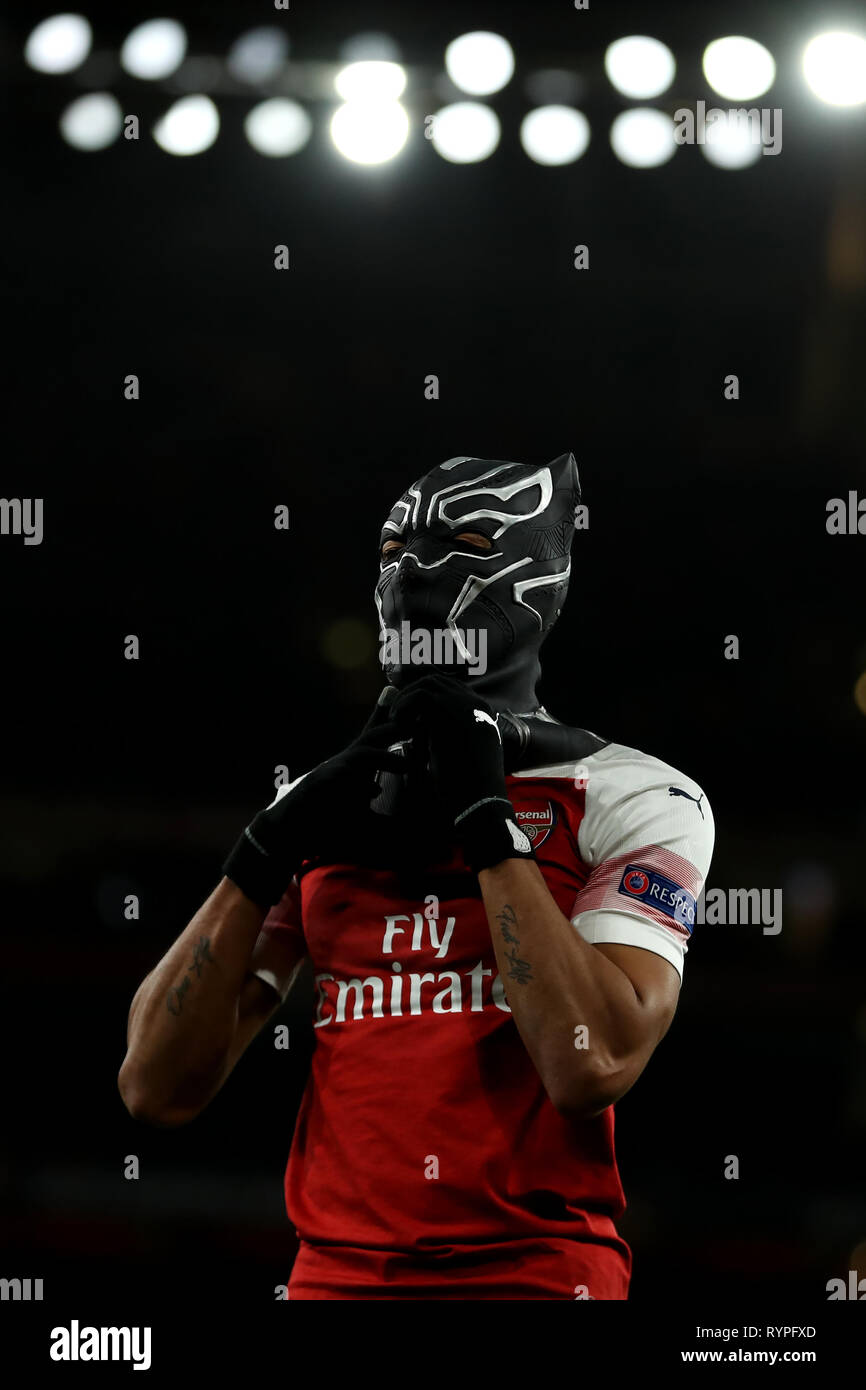 Emirates Stadium, London, UK. 14th Mar, 2019. UEFA Europa League football,  round of 16, second leg, Arsenal versus Rennes; Pierre-Emerick Aubameyang  of Arsenal celebrates in a black panther mask as he scores