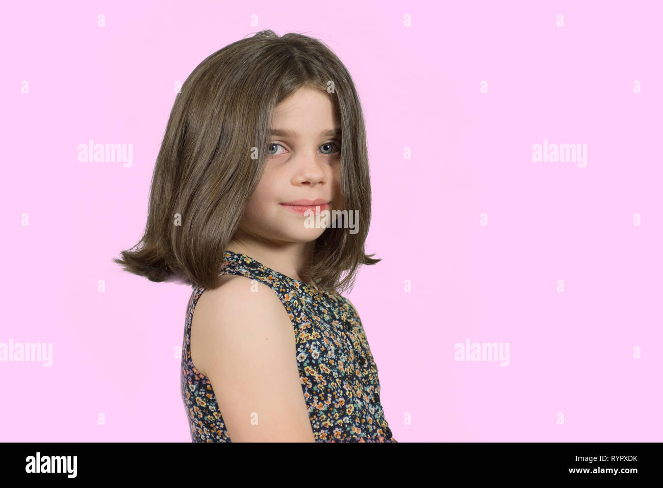 Confident Little Girl With Short Hair With Pink Background