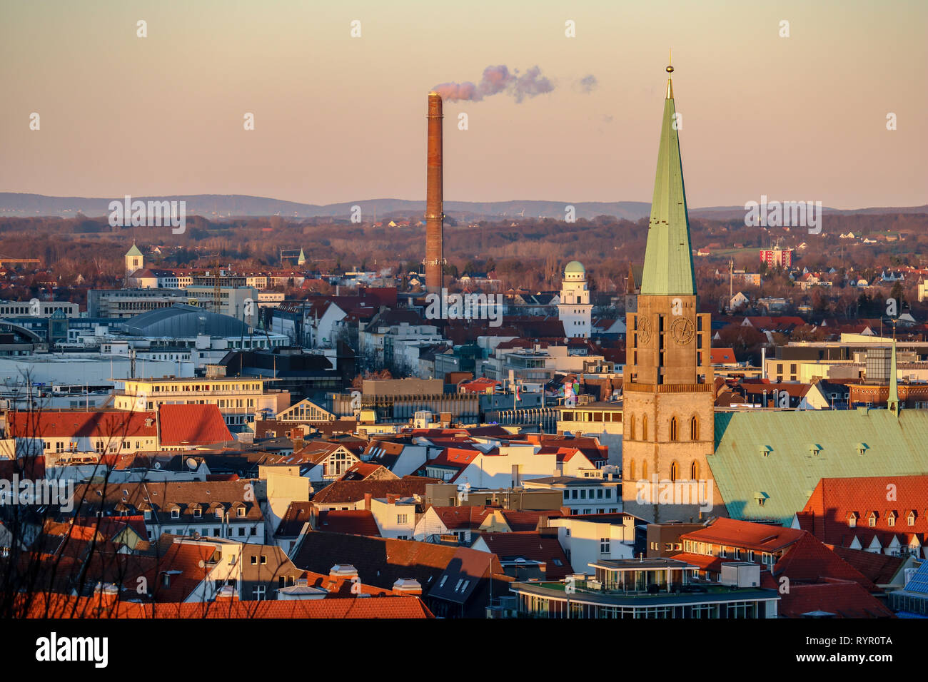 Panorama of Bielefeld, Germany with the Nikolaikirche and a smoking chimney Stock Photo