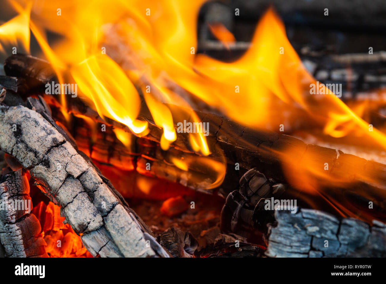 Image of burning firewood. Fire, flames, charred wood. Closeup view. Warming and cozy background or backdrop Stock Photo