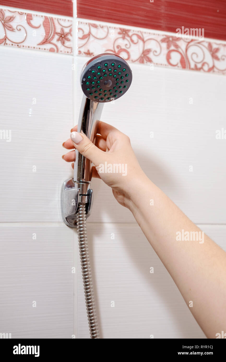 shower in female hand in bathroom Stock Photo - Alamy
