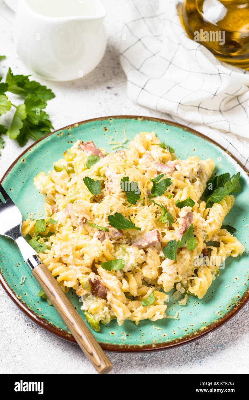 Pasta carbonara with zucchini in craft plate on white Stock Photo Alamy
