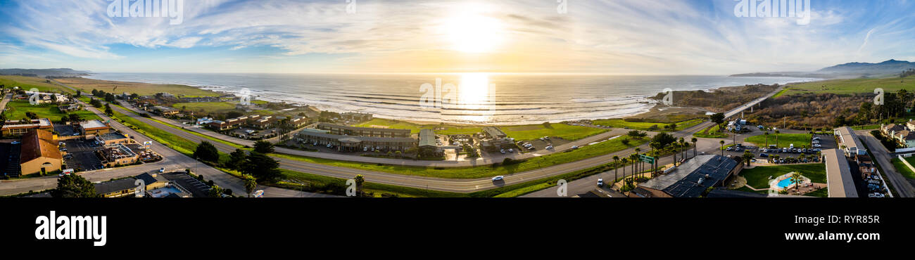 4K Aerial at shoreline of the Pacific ocean coast on a sunset, San Simeon, central California Stock Photo