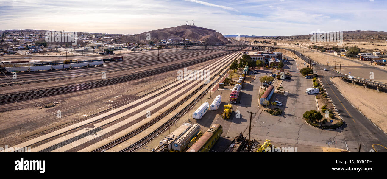 Aerial view of Barstow community a residential city of homes and commercial property community Mojave desert California USA at sunset. Railway Station Stock Photo
