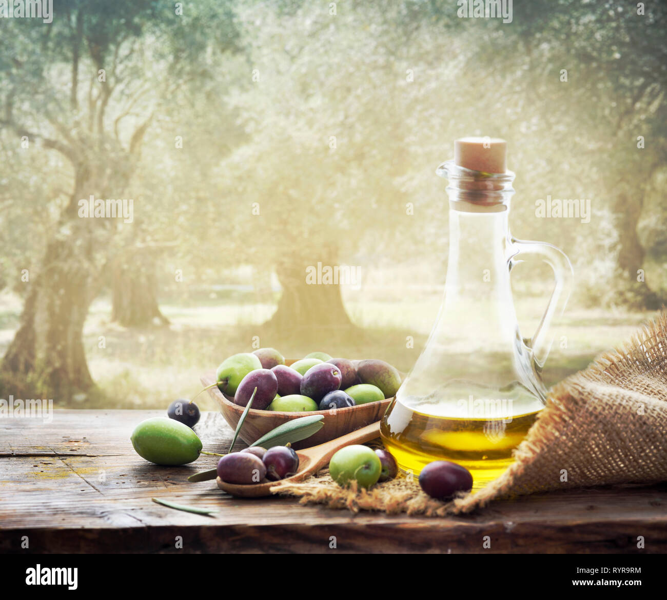 Olives and bottle of Extra virgin olive oil on wooden table in olive