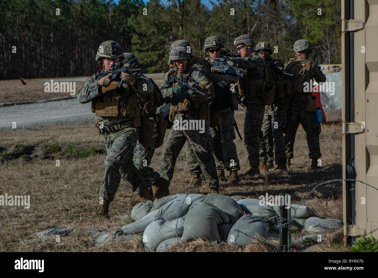 U.S. Marines with 2nd Combat Engineer Battalion, 2nd Marine Division, stack behind a barrior while conducting urban demolition training during the annual SAPPER Squad Competition on Camp Lejeune, N.C., March 13, 2019. Marines from four squads compete against each other for a week to test their strengths within the occupational field and build comradery while maintaining mission readiness. (U.S. Marine Corps photo by Lance Cpl. Nathaniel Q. Hamilton) Stock Photo
