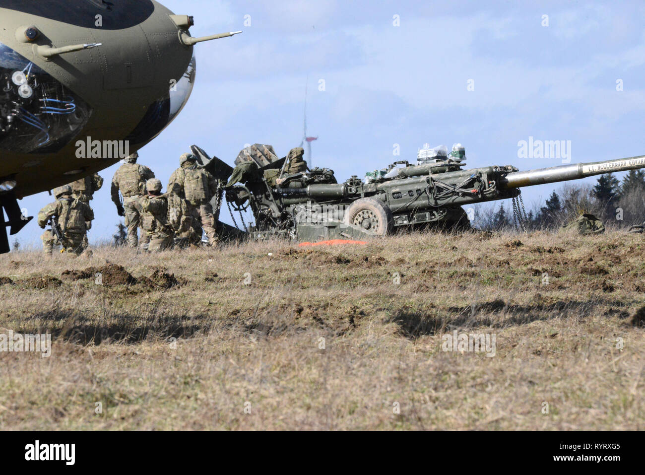 U.S. Army Soldiers assigned to Bulldog Battery, Field Artillery Squadron, 2d Cavalry Regiment, prepare a M777 Howitzer during an air assault mission at the 7th Army Training Command’s Grafenwoehr Training Area, Germany, March 12, 2019. (U.S. Army photo by Matthias Fruth) Stock Photo