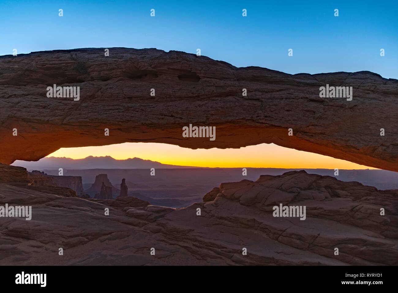 View through Natural Arch, Mesa Arch, Sunrise, Grand View Point Road, Island in the Sky, Canyonlands National Park, Moab, Utah Stock Photo