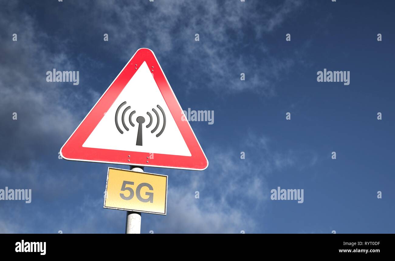 Warning sign against blue sky with clouds, warning against 5G radiation, 5G network, Germany Stock Photo