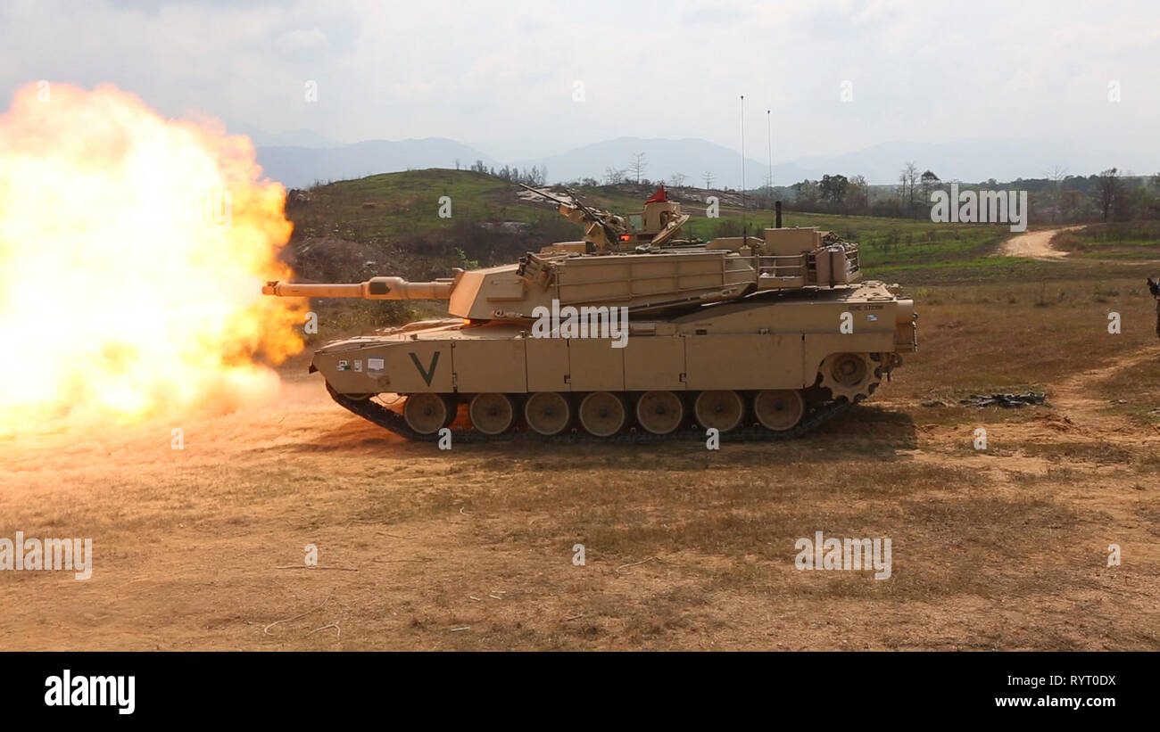 An M1A1 Abrams main battle tank conducts joint live fire training on Camp Ban Chan Krem, Royal Kingdom of Thailand, Feb. 12, 2019. U.S. Marines with Marine Wing Support Squadron 172, Marine Light Attack Helicopter Squadron 267, 1st Marine Aircraft Wing, and 4th Tank Battalion conducted joint live fire training with Marine Corps Infantry and Royal Thai Infrantry. This training displayed our strength and cohesion during combat simulated situations. Cobra Gold is a Thailand and United States co-sponsored Combined Joint Task Force and joint theatre security operation exercise conducted with up to  Stock Photo