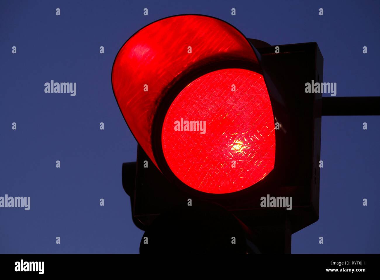Traffic light shows red at dusk, Germany Stock Photo