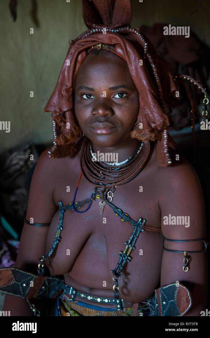 Himba woman sitting in her hut, Kaokoland, Namibia Stock Photo