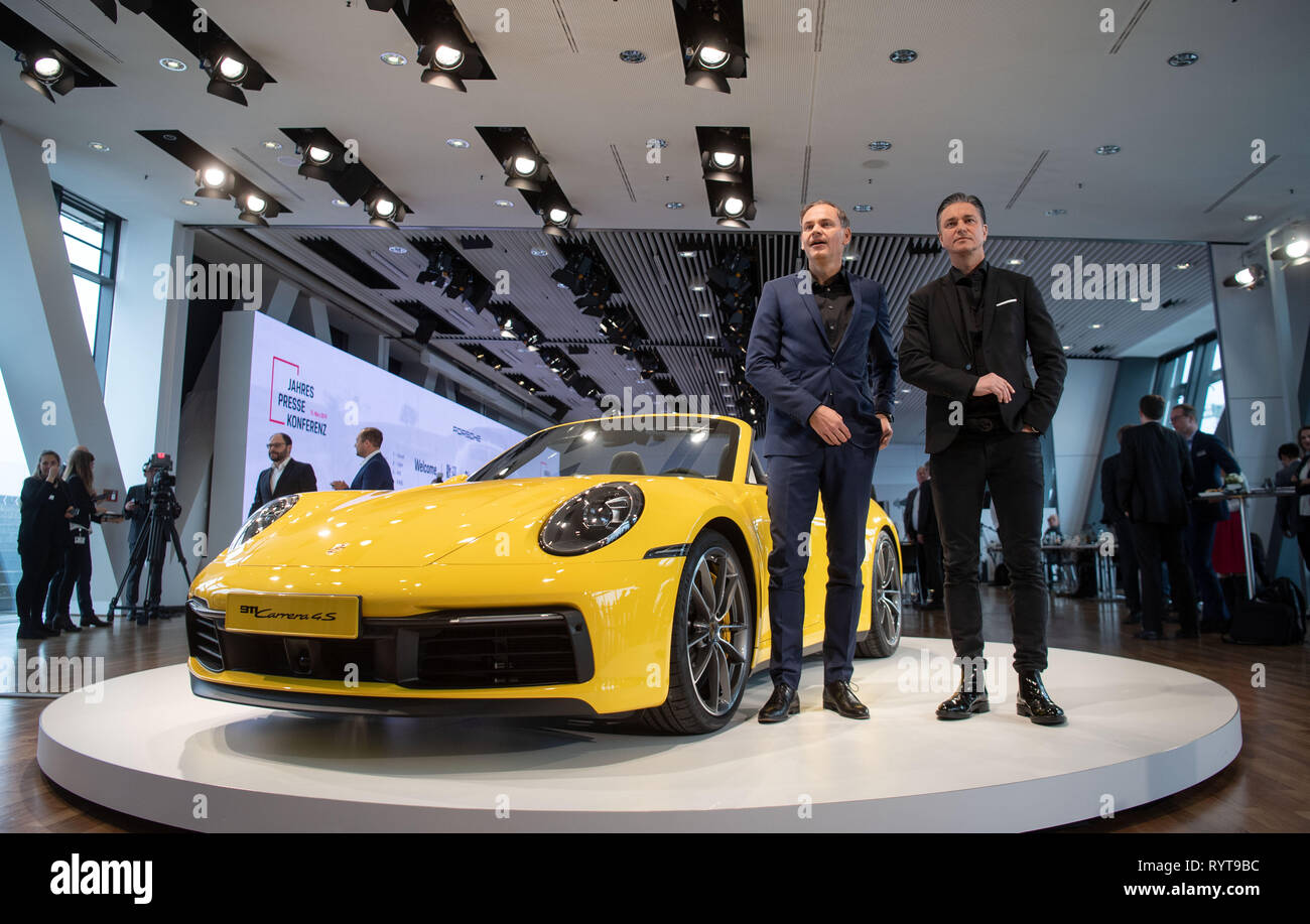 Stuttgart, Germany. 15th Mar, 2019. Oliver Blume, CEO of Porsche AG (l) and  Lutz Meschke, CFO of Porsche AG, are standing next to a Porsche 911 Carrera  4S Cabrio at the company's