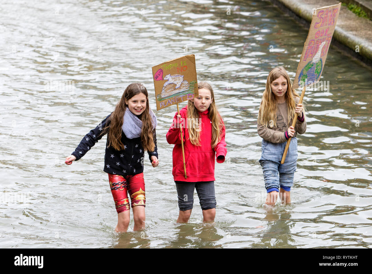 Bristol, UK. 15th March, 2019. Bristol college students and school children carrying climate change placards and signs are pictured standing in the moat outside Bristol City Hall as they protest against Climate change. The pupils who also went on strike last month walked out of school again today as part of a countrywide coordinated strike action to force action on climate change policy. Credit: lynchpics/Alamy Live News Stock Photo