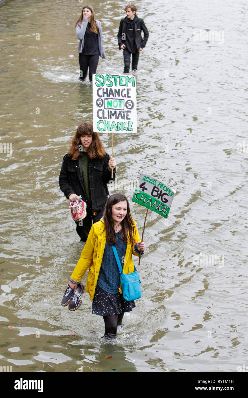 Bristol, UK. 15th March, 2019. Bristol college students and school children carrying climate change placards and signs are pictured standing in the moat outside Bristol City Hall as they protest against Climate change. The pupils who also went on strike last month walked out of school again today as part of a countrywide coordinated strike action to force action on climate change policy. Credit: lynchpics/Alamy Live News Stock Photo