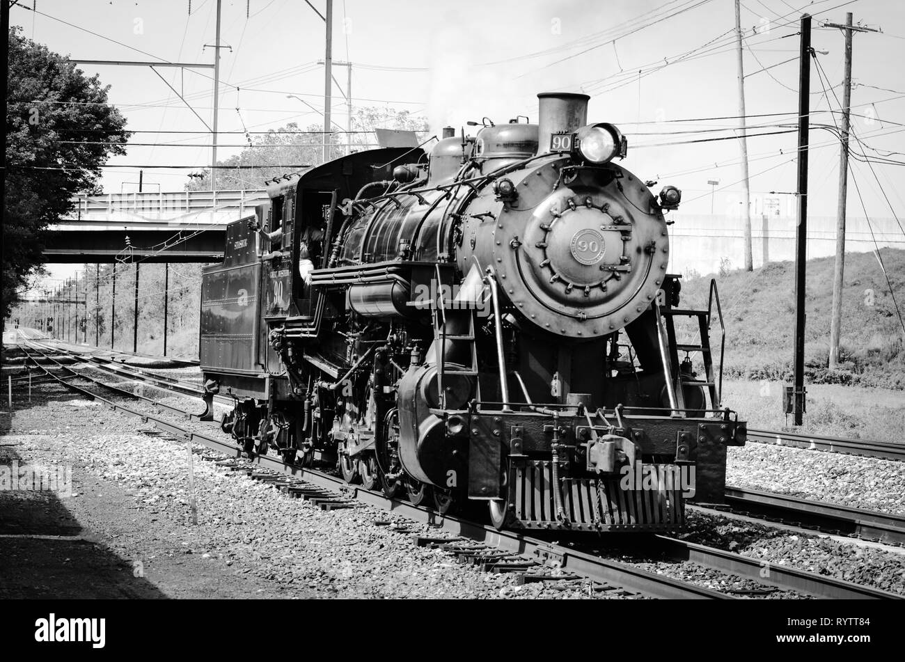 Vintage train steam engine sitting on the railroad tracks Stock Photo