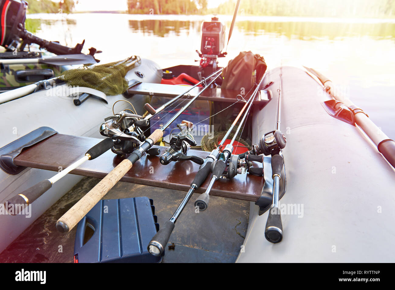 Fishing rods with spinning reels in a boat Stock Photo Alamy